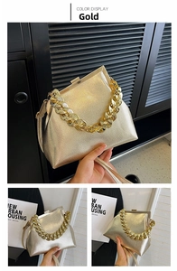 Close-up of gold chain handle and lychee texture on the metallic evening handbag