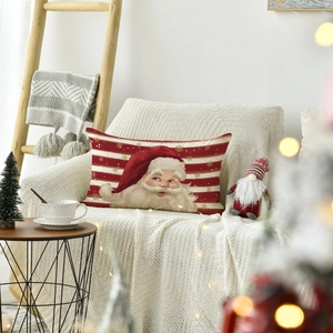 Detail of linen Christmas pillowcase with Santa Claus and snowflakes on a white knit blanket