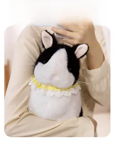 Close-up of soft plush bunny with yellow plaid lace collar held in hand for scale