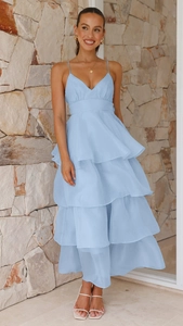 Detail of light blue layered ruffle hem on backless evening dress with chiffon fabric