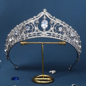 Detailed macro view of silver bridal tiara with large oval crystal on a T-stand