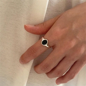 Minimalist 925 sterling silver ring featuring a smooth oval black onyx gemstone on finger