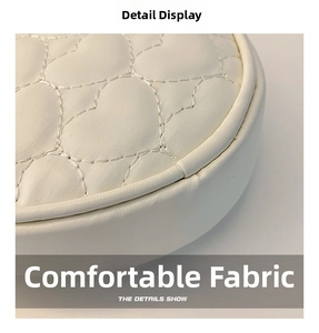 Close-up of premium white leather texture with elegant heart quilted stitching details