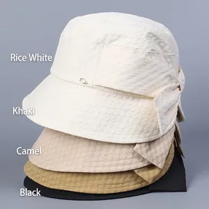 Elegant women's seersucker bucket hats with bow tie detail in four essential colors