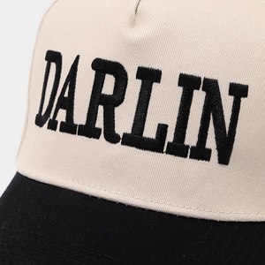 Close-up of the DARLIN embroidery on a two-tone cotton trucker hat with clean stitching