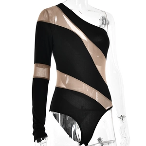 Detail view of asymmetric black bodysuit with beige mesh patchwork and sheer long sleeve