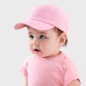 Detailed close-up of pink cotton baseball cap fabric texture and breathable eyelets