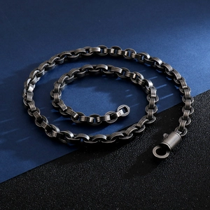 Detail of a vintage silver-grey Cuban link chain necklace with high-end spring clasp
