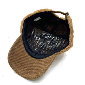 Detail view of winter baseball cap showing brown corduroy and warm lamb wool lining