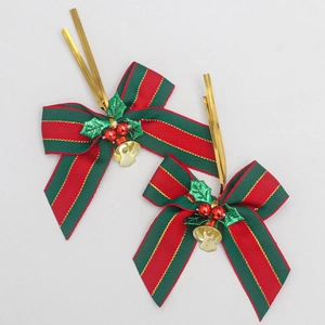 Detail of red and green striped Christmas bows with gold bells and berry ornaments