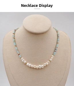 Detailed close-up of Baroque freshwater pearls and blue gemstone beads on necklace