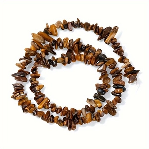 Macro shot of irregular natural tiger eye stone beads for handmade jewelry making