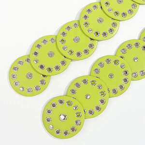 Close-up of neon green leather belt with silver rivets and metal eyelets detail