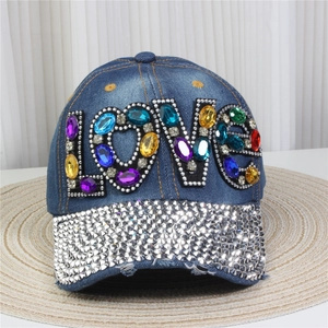Close-up of blue denim baseball cap with LOVE crystal lettering and silver rhinestone brim