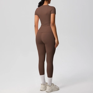 Rear view detail of a brown two-piece yoga set showing slim fit top and high waist leggings