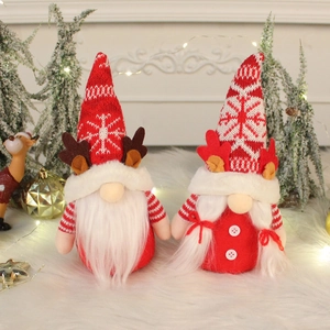 Pair of Christmas gnome plushies with knitted snowflake hats and reindeer antlers