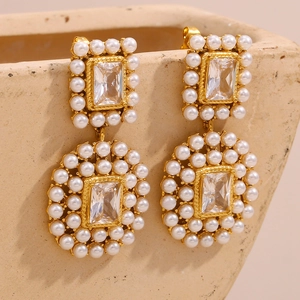 Detailed close-up of 18K gold-plated earring with large zircon and pearl border