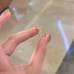 Minimalist wavy gold titanium steel ring with textured finish for a stylish luxury look