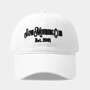 Close-up of SLOW MORNING CLUB black embroidery on a white cotton 6-panel baseball cap