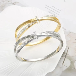 Chic interlocking roman numeral bangle set in gold and silver finish with crystal pavé