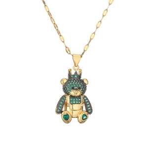 Charming gold teddy bear necklace with green and black crystals on a thin chain