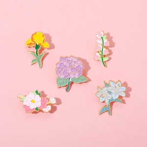 Ensemble de broches fleurs en émail avec lys et hortensia sur fond rose doux