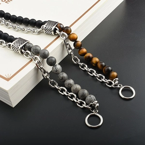 Detailed macro view of tiger eye stones and matte black beads with silver metal chains