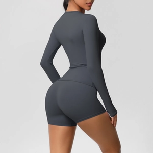 Detail view of dark grey slim-fit yoga set with high-stretch fabric on a studio model