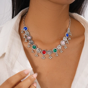 Close-up of vintage flower pendant necklace with colorful rhinestones on a model