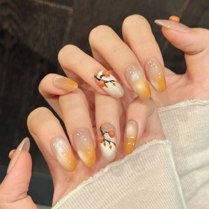 Detailed view of handmade persimmon cat-eye nails with 3D hand-painted fruit patterns