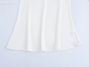 Detail of white floral set showing the delicate stitching and smooth fabric texture