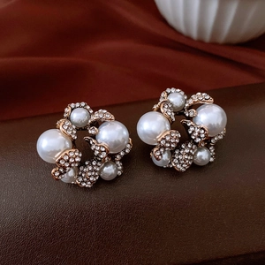Primo piano di orecchini vintage a fiori con perle e strass scintillanti