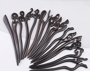 Collection of hand-carved ebony wood hairpins with traditional Chinese patterns and motifs