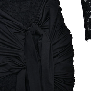 Detail view of the knotted waist design and lace trim on a slim fit black summer dress