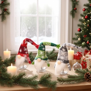 Three Christmas gnome candy jars with knit hats and clear bases on a festive window sill