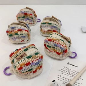 Close-up of colorful handmade woven earphone cases with zippers and hanging hooks