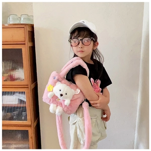 Detail of pink faux fur kids bag featuring 3D teddy bear and soft plush strap