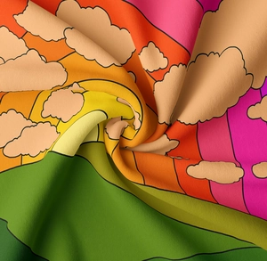 Close-up of soft bohemian rainbow tapestry fabric with cartoon cloud and hill patterns