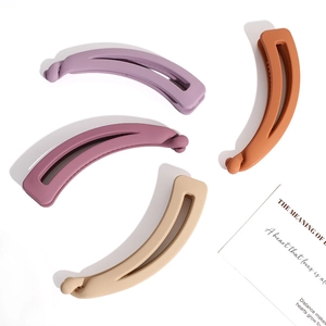 Matte banana hair clips in lavender, burgundy, orange and beige colors on white background