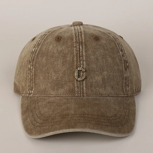 Detail view of the vintage washed cotton baseball cap with metallic C logo badge