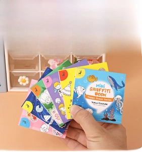 Mini cartoon graffiti books set with ocean theme held in hand for children's painting