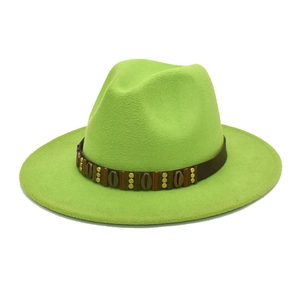 Close-up of neon green fedora hat with brown leather band and vintage metal studs