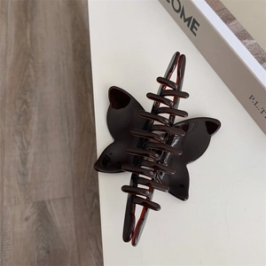 Detail view of large tortoiseshell acetate butterfly hair claw clip with glossy finish