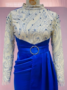 Close-up of baroque silver glitter and blue pearls on sheer mesh of a long evening gown
