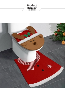 Detail of reindeer themed Christmas toilet seat cover and red snowflake floor mat set