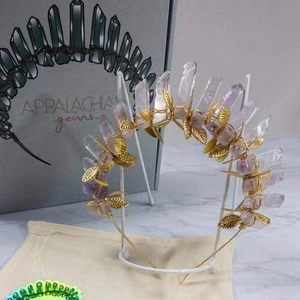Detail of golden leaf headband with natural amethyst stones and beige cotton dust bag