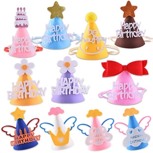 Flat lay of colorful DIY felt birthday hats with cake and crown designs for kids