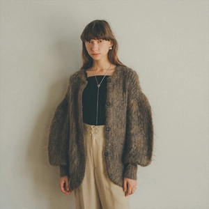 Detail view of the soft mohair texture and large round buttons on a brown knit cardigan