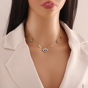 Gold stainless steel necklace with crown evil eye and hand of fatima charms on model