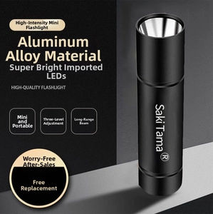 Close-up of a mini black aluminum LED flashlight with three-level adjustment settings